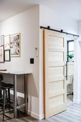 a sliding door in a room with a table at Downtown Oasis-2BR-Spa Bath-Pet Friendly, Free Parking in Toronto