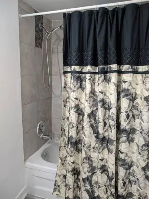 a bathroom with a shower and a shower curtain at Cozy basement apartment in the heart of Oakville in Oakville