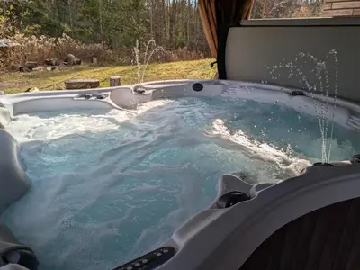 a hot tub with water coming out of it at The Nest in the Forest Bed and Breakfast (Hot tub and Sauna) in Lakefield
