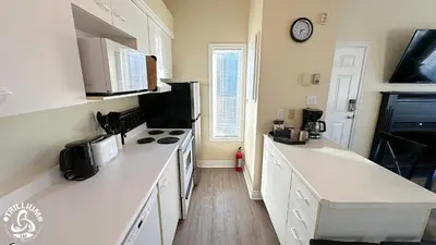a kitchen with white counters and a stove top oven at Mountainview Loft at North Creek Resort in Blue Mountains