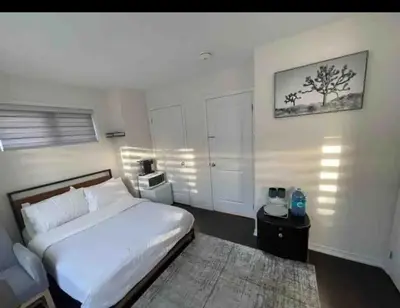 a bedroom with a white bed and a rug at Ensuite guest room with separate entrance in Mississauga
