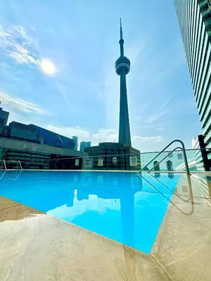 a swimming pool with a view of the berlin tower at The Vine & View Suite in Toronto