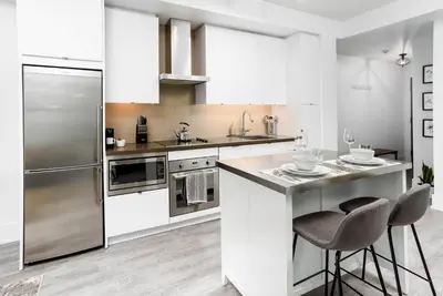 a kitchen with stainless steel appliances and a counter at The Vine & View Suite in Toronto