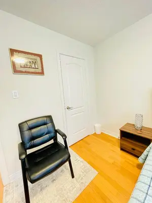 a black chair in a room with a table at Homestay- private room and bathroom in Whitby