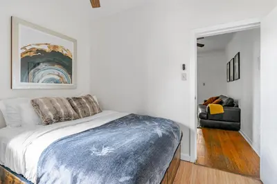 a bedroom with a bed with a blue blanket at Cozy 2 Bedroom 2 Bathroom with Parking in Toronto