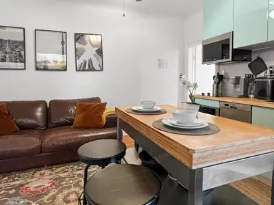 a living room with a table and a couch at Cozy 2 Bedroom 2 Bathroom with Parking in Toronto
