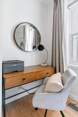 a mirror and a chair in a living room at Cozy 2 Bedroom 2 Bathroom with Parking in Toronto