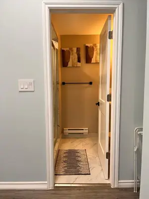 a door leading into a hallway with a rug at Private Apartment/Suite in Whitby