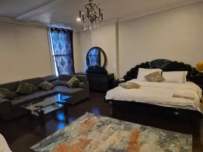 a living room with a bed and a couch at Downtown apartment 2-3 people in Bowmanville