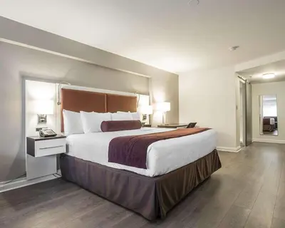 a hotel room with a large bed and two lamps at The Saint James Hotel, an Ascend Collection Hotel in Toronto