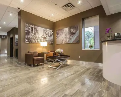 a lobby with a waiting room with a chair and a table at The Saint James Hotel, an Ascend Collection Hotel in Toronto