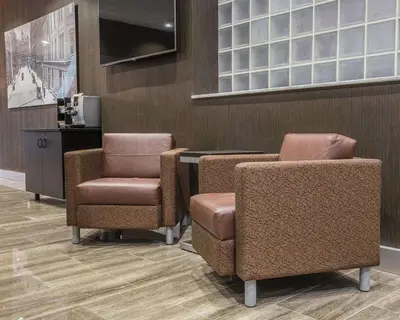 a waiting room with two chairs and a desk at The Saint James Hotel, an Ascend Collection Hotel in Toronto