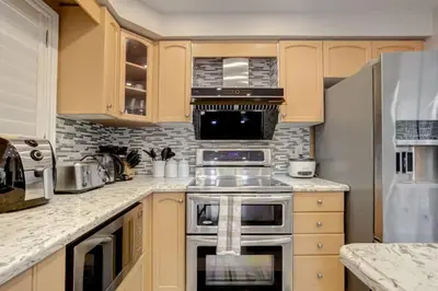 a kitchen with a stove and a refrigerator at 4-BR Family Haven - Near Wonderland and Vaughan Mills in Vaughan
