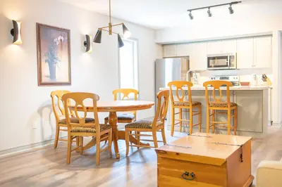 a kitchen and dining room with a table and chairs at Horseshoe Valley Suites - The Evergreen in Shanty Bay
