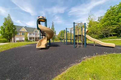 a playground with two slides in a park at Horseshoe Valley Suites - The Evergreen in Shanty Bay