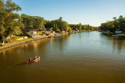 two people in a red boat on a river at Charming riverside cottage, walk to beach in Wasaga Beach