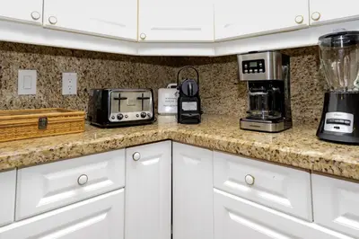 a kitchen with a counter top with appliances on it at Charming riverside cottage, walk to beach in Wasaga Beach