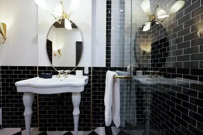 a bathroom with a white sink and a mirror at The Dorchester Hotel in Collingwood