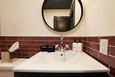 a bathroom with a sink and a mirror at The Dorchester Hotel in Collingwood