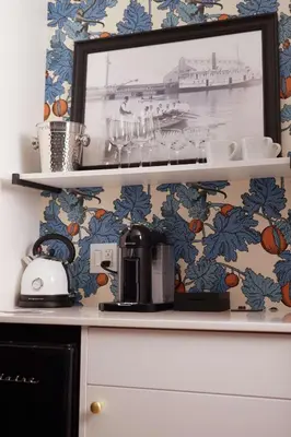 a kitchen with a coffee maker on a shelf at The Dorchester Hotel in Collingwood