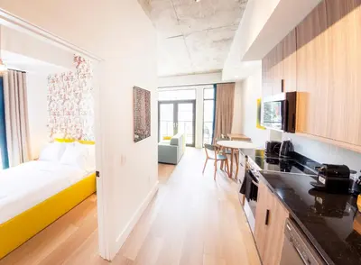 a kitchen and a living room with a bed in a room at The Laundry Rooms Augusta in Hamilton