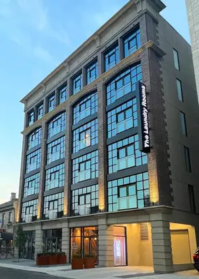 a large building with many windows on a street at The Laundry Rooms Augusta in Hamilton
