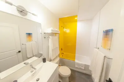 a white bathroom with a sink and a toilet at The Laundry Rooms Augusta in Hamilton