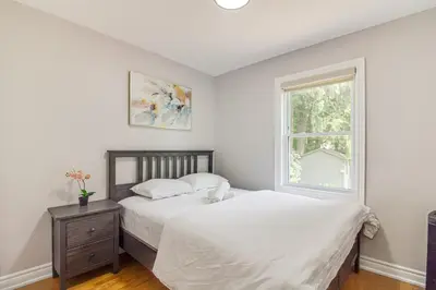 a bedroom with two beds and a window at Beautiful house near bluffers beach, 25 minutes to Toronto Downtown, free parking, and wifi in Toronto