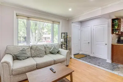 a living room with a couch and a table at Beautiful house near bluffers beach, 25 minutes to Toronto Downtown, free parking, and wifi in Toronto