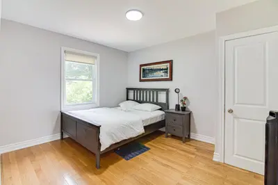 a bedroom with a bed and a window at Beautiful house near bluffers beach, 25 minutes to Toronto Downtown, free parking, and wifi in Toronto