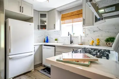 a kitchen with white appliances and a white refrigerator at 2 Bedroom East-York bungalow in Toronto