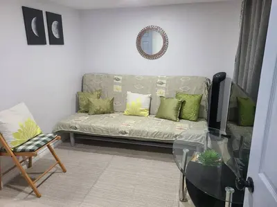 a living room with a couch and a glass table at 2 bedroom + Bath in Eastyork in Toronto