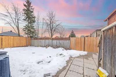 a backyard covered in snow with a wooden fence at 2 bedroom + Bath in Eastyork in Toronto