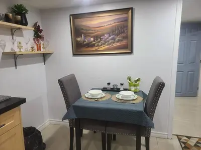 a dining room table with chairs and a painting on the wall at 2 bedroom + Bath in Eastyork in Toronto