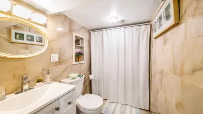 a bathroom with a toilet and a sink and a shower at 2 bedroom + Bath in Eastyork in Toronto