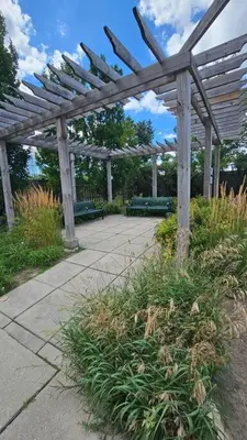 a wooden pergola with benches in a garden at Modern 2BR Townhouse w Patio & Free Parking Family & Work Stays in Toronto