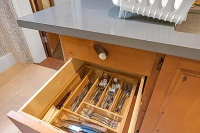a drawer in a kitchen cabinet with utensils at Hidden Oasis with Hot Tubs, & Starry Fire Pits in Borden