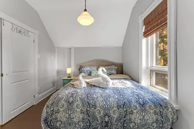 two swans sitting on a bed in a bedroom at Hidden Oasis with Hot Tubs, & Starry Fire Pits in Borden