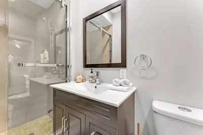 a bathroom with a sink and a shower and a mirror at Hidden Oasis with Hot Tubs, & Starry Fire Pits in Borden