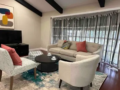 a living room with a couch and chairs and a table at Vacation paradise in St. Catharines