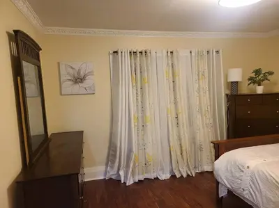 a bedroom with a bed and a dresser and a window at 3 BR House in Toronto Downtown in Toronto