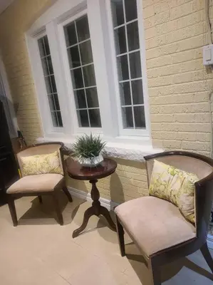 two chairs and a table in front of a window at 3 BR House in Toronto Downtown in Toronto