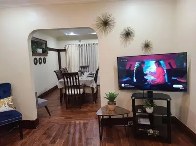 a living room with a flat screen tv on the wall at 3 BR House in Toronto Downtown in Toronto