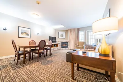 a living room with a table and chairs and a couch at Horseshoe Valley Suites - The Azure in Shanty Bay