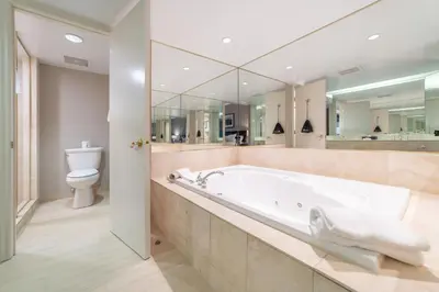 a large bathroom with a tub and a toilet at Horseshoe Valley Suites - The Azure in Shanty Bay