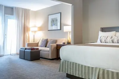 a hotel room with a bed and a couch at Horseshoe Valley Suites - The Azure in Shanty Bay