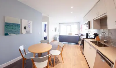 a kitchen with a table and chairs in a room at The Laundry Rooms Gaslight Cambridge in Cambridge