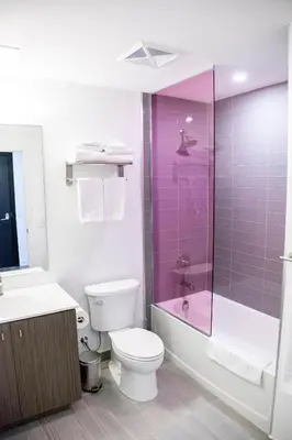 a bathroom with a toilet and a sink and a shower at The Laundry Rooms Station Park Kitchener in Kitchener