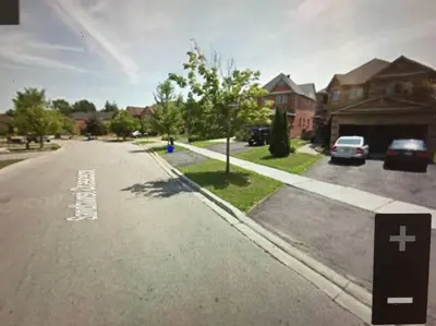 an empty street in a residential neighborhood with houses at Large Separate Entrance Basement Unit 2Beds 1Washroom Sleeps 4-6 in Pickering