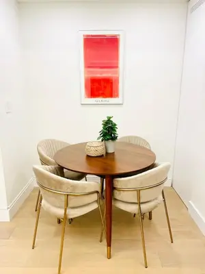 a dining room table and chairs with a plant on it at Urban 2-bed apartment in the Beaches in Toronto